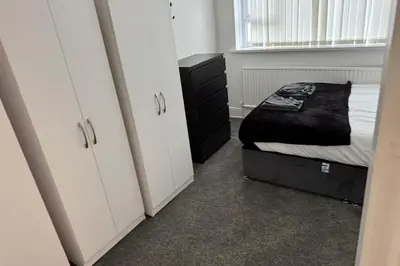 a small bedroom with a bed and a dresser at 1BR in Blackpool l Sleeps 4, Wi-Fi & Full Kitchen in Blackpool
