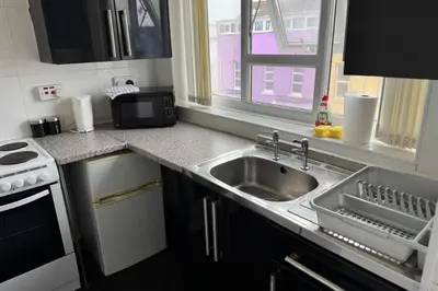 a kitchen with a sink and a stove and a window at 1BR in Blackpool l Sleeps 4, Wi-Fi & Full Kitchen in Blackpool