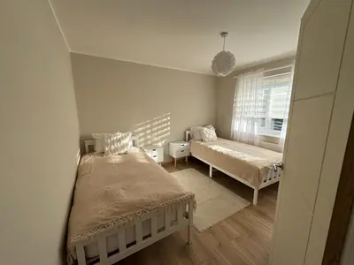 a small bedroom with two beds and a window at Livs cozy corner in Crossens