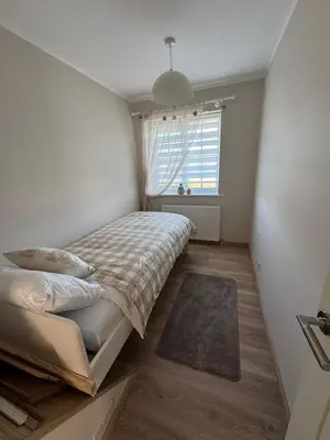 a small bedroom with a bed and a window at Livs cozy corner in Crossens