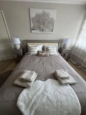 a bedroom with a large bed with white blankets and pillows at Livs cozy corner in Crossens
