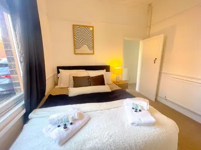 a bedroom with a bed with towels on it at Three Bedroom House by Brookland Stays Serviced Accommodation & Short Lets in Preston with Free WiFi in Preston