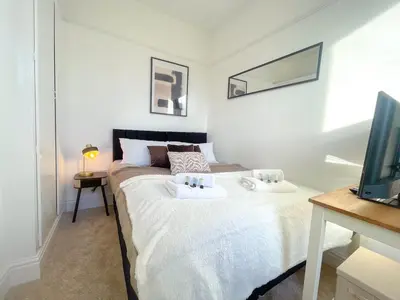 a bedroom with a bed with two pillows on it at Three Bedroom House by Brookland Stays Serviced Accommodation & Short Lets in Preston with Free WiFi in Preston