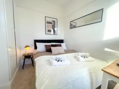 a bedroom with a bed with two towels on it at Three Bedroom House by Brookland Stays Serviced Accommodation & Short Lets in Preston with Free WiFi in Preston