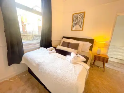 a bedroom with a bed with two stuffed animals on it at Three Bedroom House by Brookland Stays Serviced Accommodation & Short Lets in Preston with Free WiFi in Preston