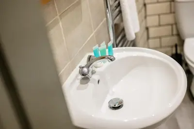 a bathroom sink with two toothbrushes on top of it at Earle House - Air Host & Stay - 5 BR - Sleeps 13 in Liverpool