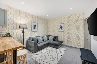 a living room with a couch and a table at Earle House - Air Host & Stay - 5 BR - Sleeps 13 in Liverpool