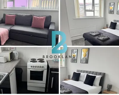 a kitchen and a living room with a couch and a stove at 1BR in Blackpool l Sleeps 4 l Contractors in Blackpool