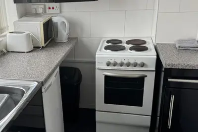a kitchen with a white stove and a sink at 1BR in Blackpool l Sleeps 4 l Contractors in Blackpool