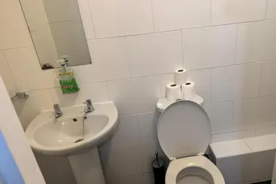 a white bathroom with a toilet and a sink at 1BR in Blackpool l Sleeps 4 l Contractors in Blackpool