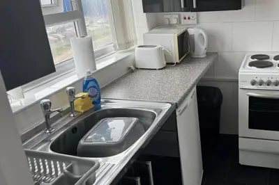 a kitchen with a sink and a microwave at 1BR in Blackpool l Sleeps 4 l Contractors in Blackpool
