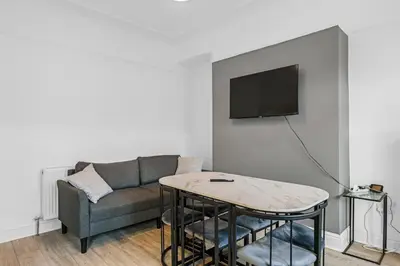 a living room with a couch and a table at 7-Bed Contractor House in Wallasey- free parking in Wallasey