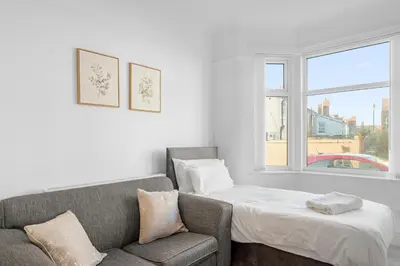 a living room with a couch and a bed at 7-Bed Contractor House in Wallasey- free parking in Wallasey