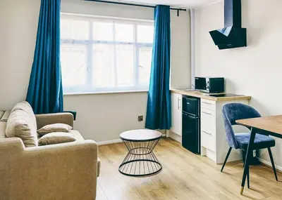 a living room with a couch and a table at Park Hall Resort And Spa in Chorley