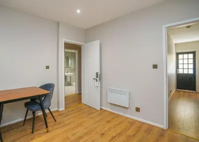 a room with a table and a chair and a door at Park Hall Resort And Spa in Chorley