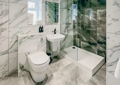 a white bathroom with a toilet and a sink at Park Hall Resort And Spa in Chorley