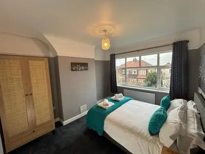 a bedroom with a bed and a large window at Stanley Suite in Liverpool