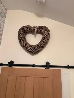 a heart shaped wreath on a wall above a door at Stanley Suite in Liverpool