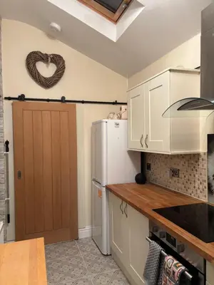 a kitchen with a refrigerator and a heart sign on the wall at Stanley Suite in Liverpool