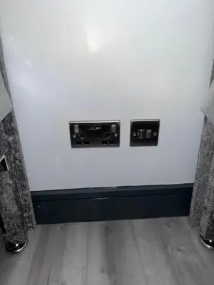 a white wall with two electrical outlets on it at The Stadium Hotel Anfield in Liverpool