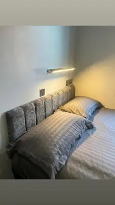 a bed in a bedroom with a headboard at The Stadium Hotel Anfield in Liverpool