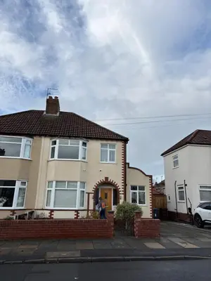 a man standing in front of a house at Thirlmere Stay in Litherland