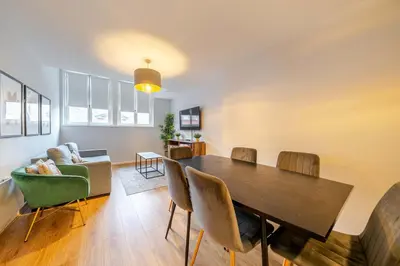 a living room with a dining room table and chairs at Host & Stay - Stanley Street Apartments in Liverpool