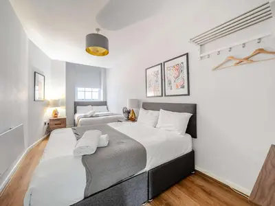 a bedroom with a large bed with white sheets at Host & Stay - Stanley Street Apartments in Liverpool