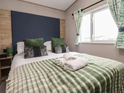 a bedroom with a bed with towels on it at The Retreat in Morecambe
