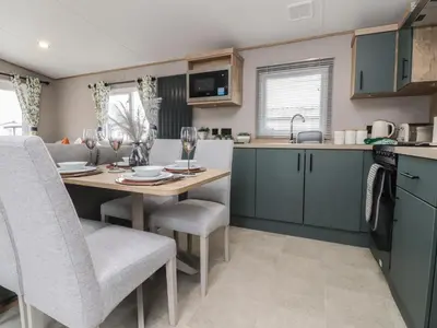a kitchen with a table and chairs in a kitchen at The Retreat in Morecambe