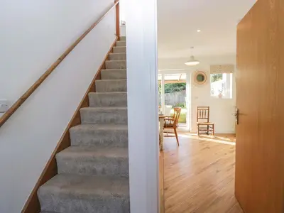 a staircase in a house with a living room at Oversands View in Grange Over Sands