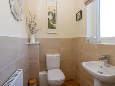 a bathroom with a toilet and a sink at Oversands View in Grange Over Sands