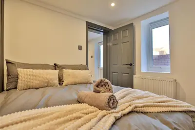 a bedroom with a bed with a blanket on it at Chesterfield House, Blackpool, Free Parking in Blackpool