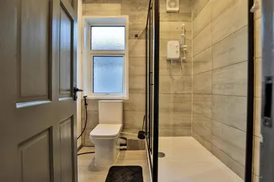 a bathroom with a toilet and a shower at Chesterfield House, Blackpool, Free Parking in Blackpool