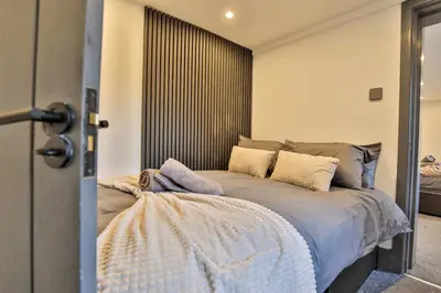 a bedroom with a bed with a large window at Chesterfield House, Blackpool, Free Parking in Blackpool