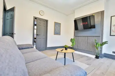 a living room with a couch and a table at Chesterfield House, Blackpool, Free Parking in Blackpool
