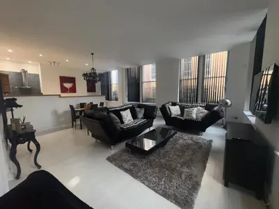 a large living room with couches and a table at Spacious 2 bed Apt Liverpool City Centre in Liverpool