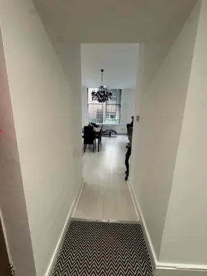 a hallway with white walls and a dining room at Spacious 2 bed Apt Liverpool City Centre in Liverpool