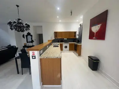 an open kitchen and living room with a counter top at Spacious 2 bed Apt Liverpool City Centre in Liverpool