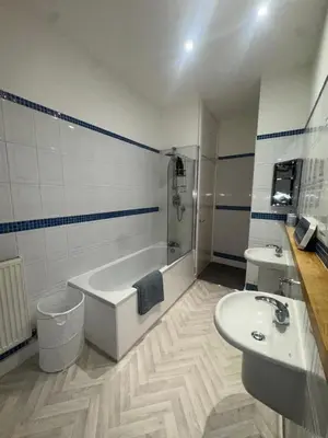a bathroom with a tub and a sink and a bath tub at Spacious 2 bed Apt Liverpool City Centre in Liverpool