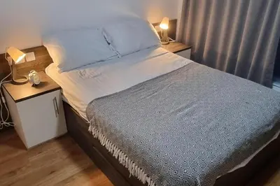 a large bed in a bedroom with two night stands at Central Liverpool 1-Bed Apartment City Centre in Liverpool