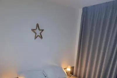 a bedroom with a star clock on the wall at Central Liverpool 1-Bed Apartment City Centre in Liverpool