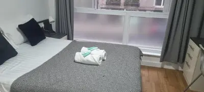 a hotel room with a bed with a towel on it at Central Liverpool 1-Bed Apartment City Centre in Liverpool