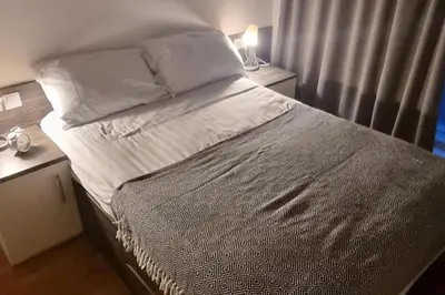 a large bed in a bedroom with two night stands at Central Liverpool 1-Bed Apartment City Centre in Liverpool