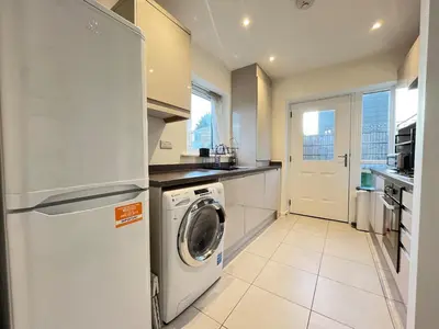 a kitchen with a washer and dryer in it at Two Bedroom House with Free Parking in Liverpool