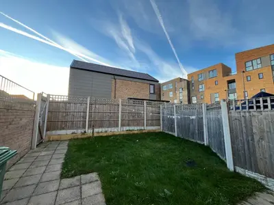 a backyard with a fence and some grass at Two Bedroom House with Free Parking in Liverpool