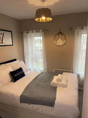 a bedroom with a bed with towels on it at 2BR Cosy Wallasey Stay Near Liverpool WiFi Parking in Wallasey