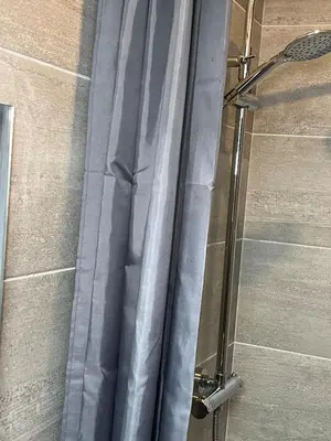a shower with a shower curtain in a bathroom at 2BR Cosy Wallasey Stay Near Liverpool WiFi Parking in Wallasey