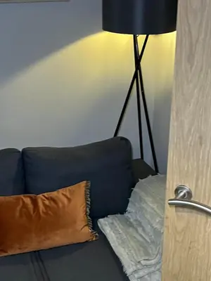 a blue couch with a pillow and a lamp at 2BR Cosy Wallasey Stay Near Liverpool WiFi Parking in Wallasey