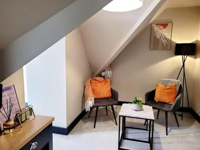 a living room with two chairs and a table at 2BR Cosy Wallasey Stay Near Liverpool WiFi Parking in Wallasey